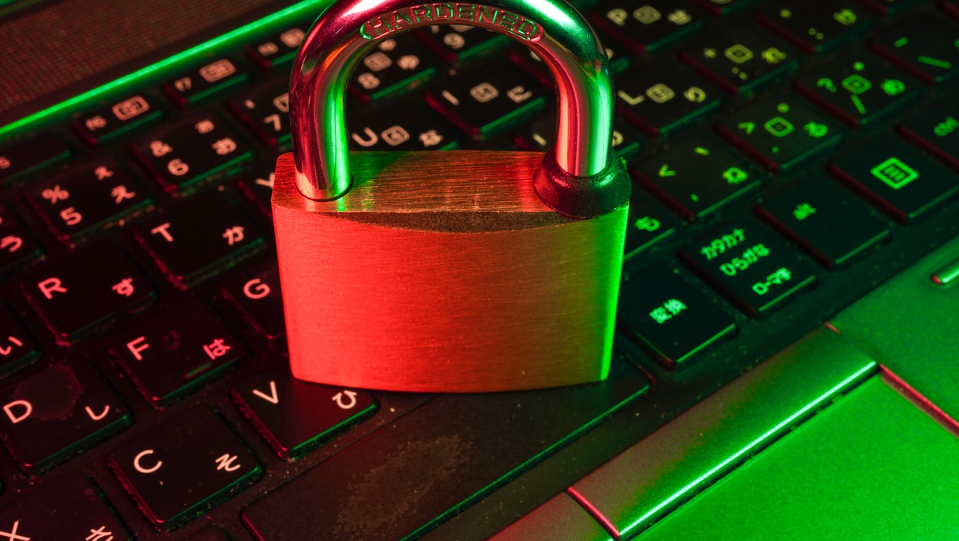 A padlock resting on a laptop keyboard, representing wallet security